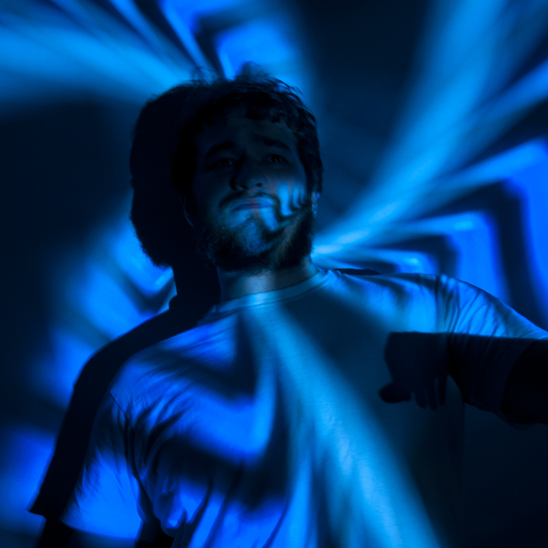 Photo of someone with blue light projected on them.