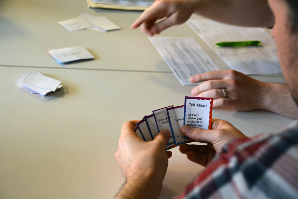 Person looking at prototype playing cards.